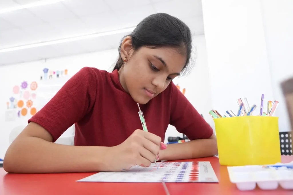 Student drawing in a creative arts class