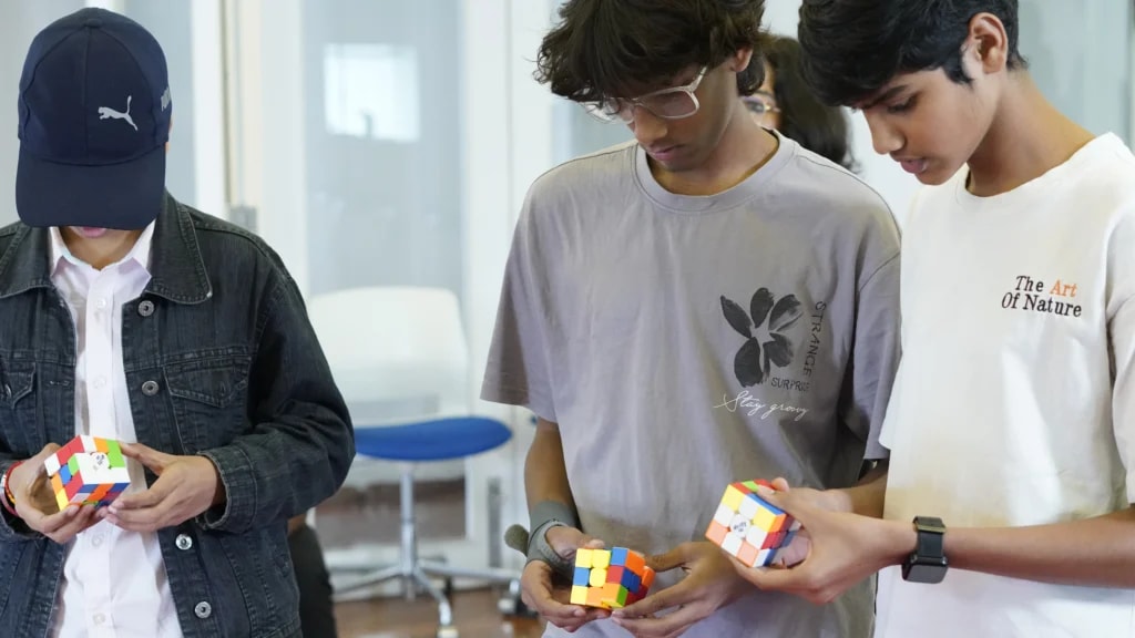 Student solving a Rubik's cube