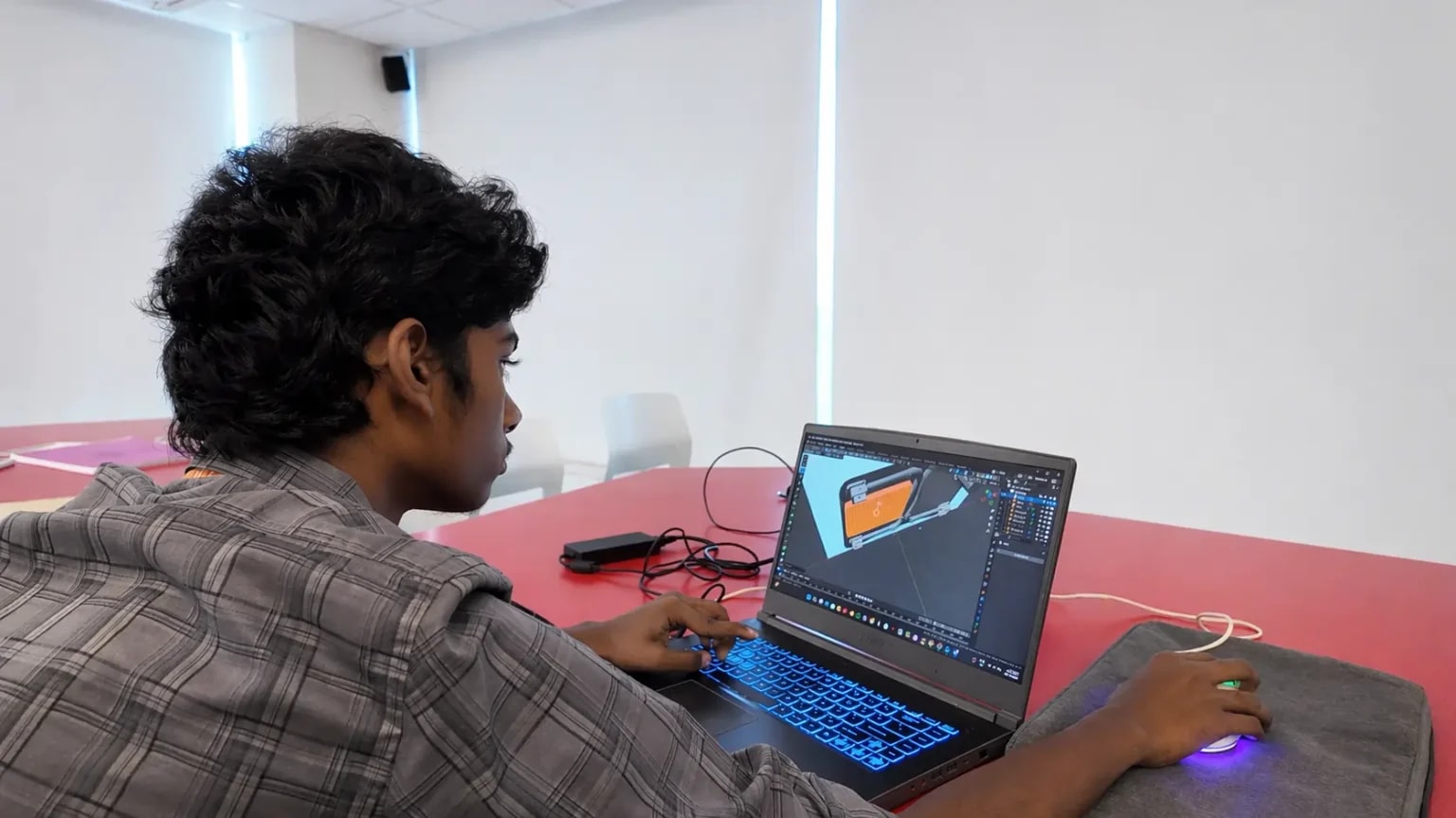 IACG student focused on a 3D design project